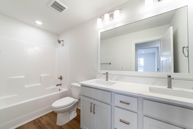 full bath featuring visible vents, a sink, toilet, and wood finished floors