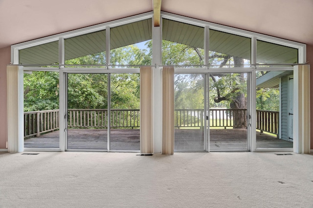 doorway to outside with vaulted ceiling with beams, carpet, and a healthy amount of sunlight