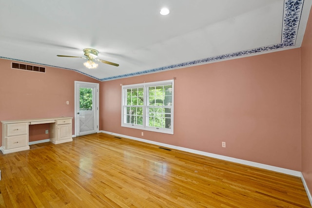 unfurnished room featuring baseboards, visible vents, and light wood-style floors