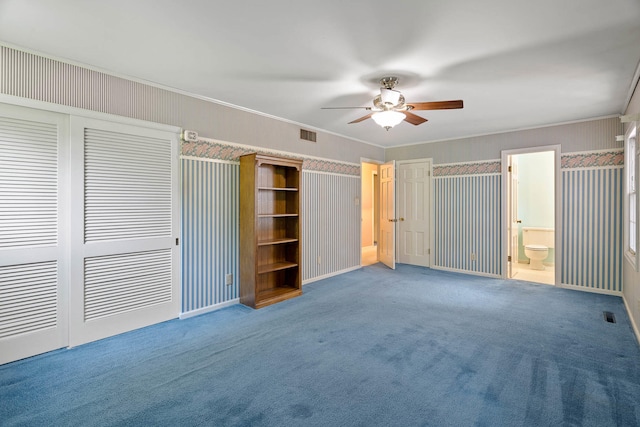 unfurnished bedroom featuring carpet floors, visible vents, crown molding, and wallpapered walls