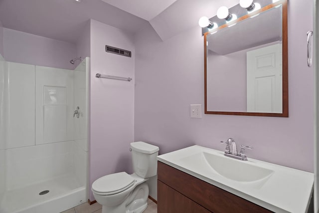 bathroom featuring toilet, tile patterned flooring, walk in shower, and vanity