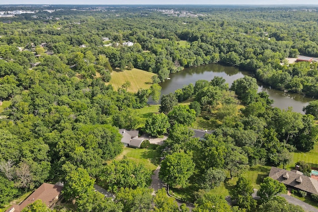 bird's eye view featuring a forest view and a water view