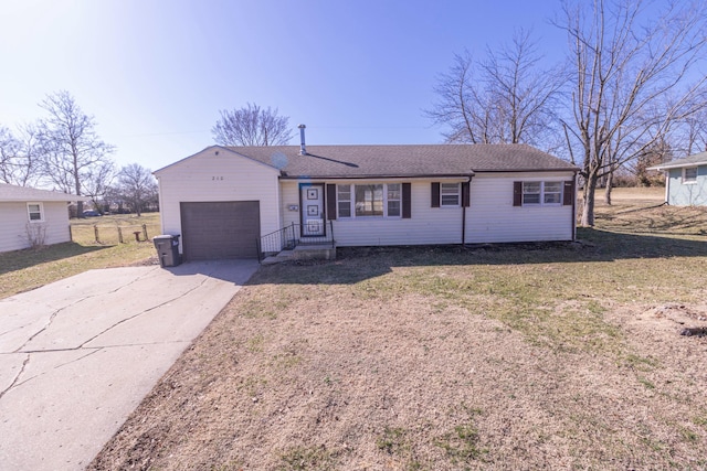 ranch-style house with concrete driveway, a garage, a front yard, and roof with shingles