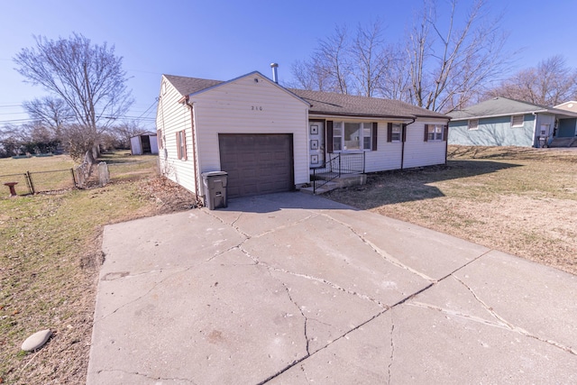 ranch-style home with concrete driveway, fence, and a garage