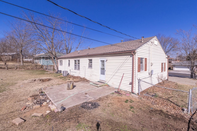 back of property featuring a patio, fence, a shingled roof, entry steps, and central air condition unit