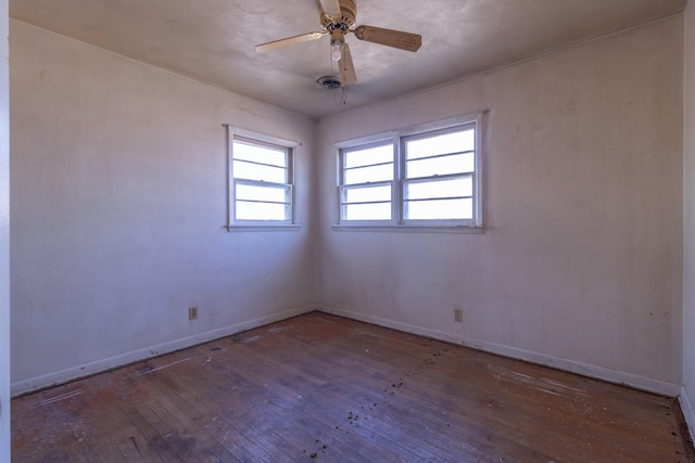 empty room with a ceiling fan, baseboards, and wood-type flooring