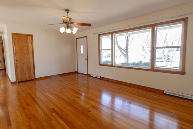 empty room featuring visible vents, baseboards, light wood-style floors, and a ceiling fan