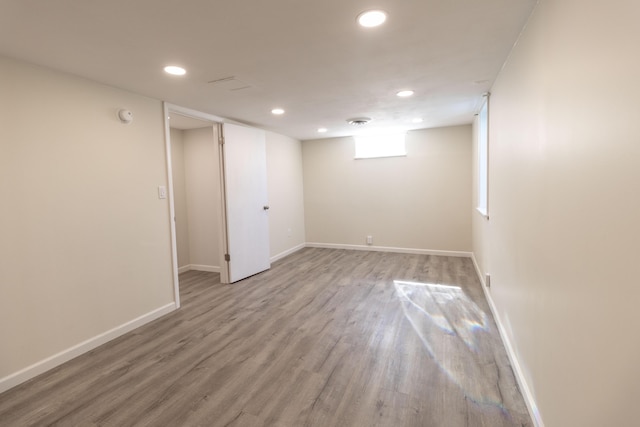 basement featuring recessed lighting, baseboards, and wood finished floors