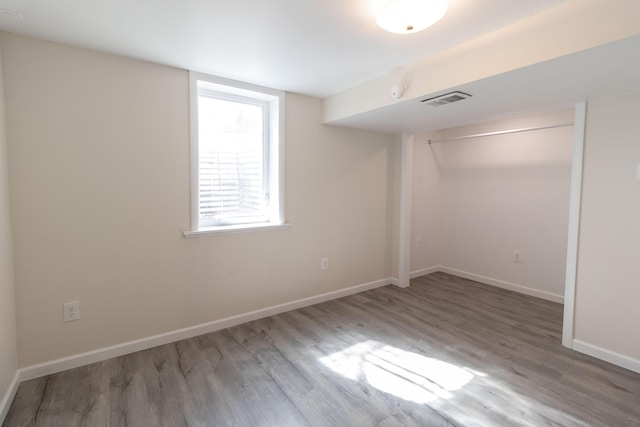 interior space featuring visible vents, baseboards, and wood finished floors