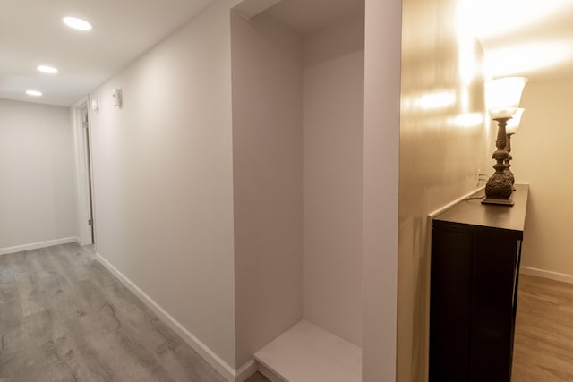 corridor with recessed lighting, baseboards, and light wood-style floors