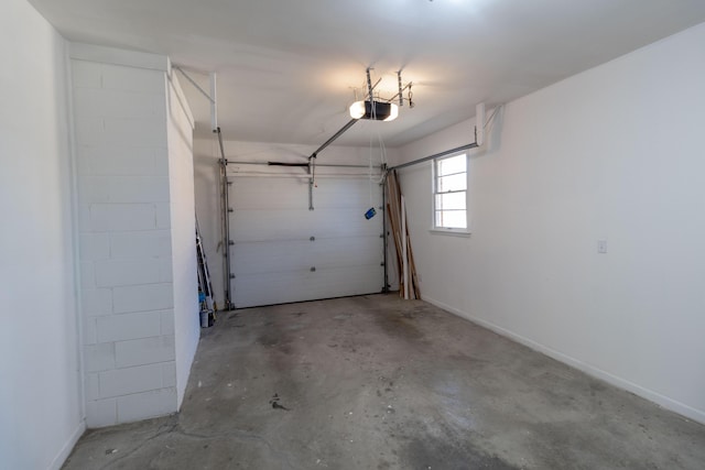 garage with a garage door opener and baseboards