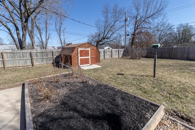 view of yard featuring an outbuilding, a fenced backyard, and a shed