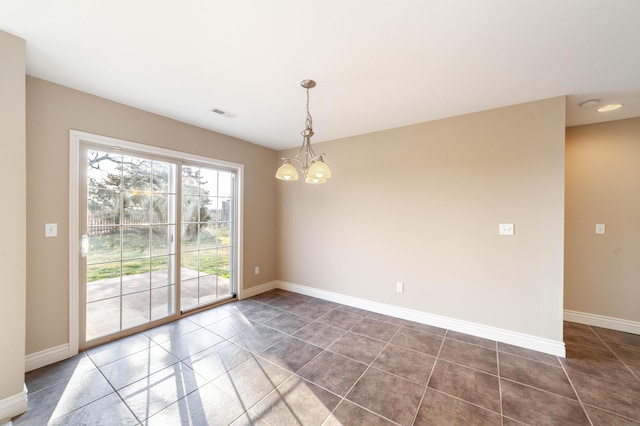 spare room featuring a notable chandelier, visible vents, baseboards, and dark tile patterned flooring