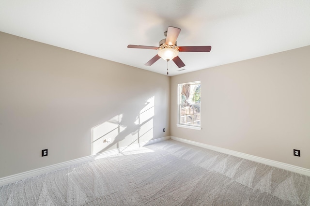 unfurnished room with baseboards, light colored carpet, and a ceiling fan