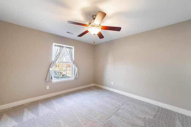 unfurnished room featuring ceiling fan, baseboards, visible vents, and light carpet