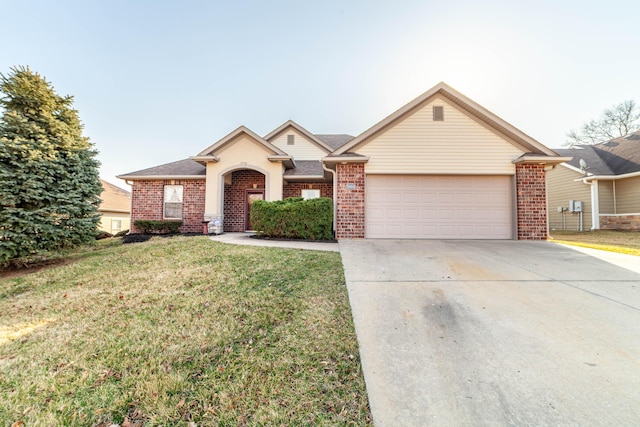 view of front of property with brick siding, driveway, an attached garage, and a front lawn