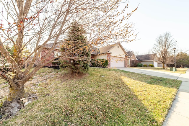 view of front of property with a front lawn, an attached garage, brick siding, and driveway