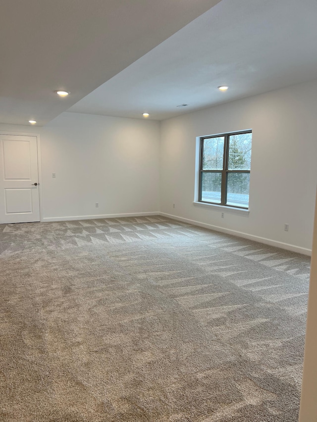 empty room with baseboards, carpet flooring, and recessed lighting