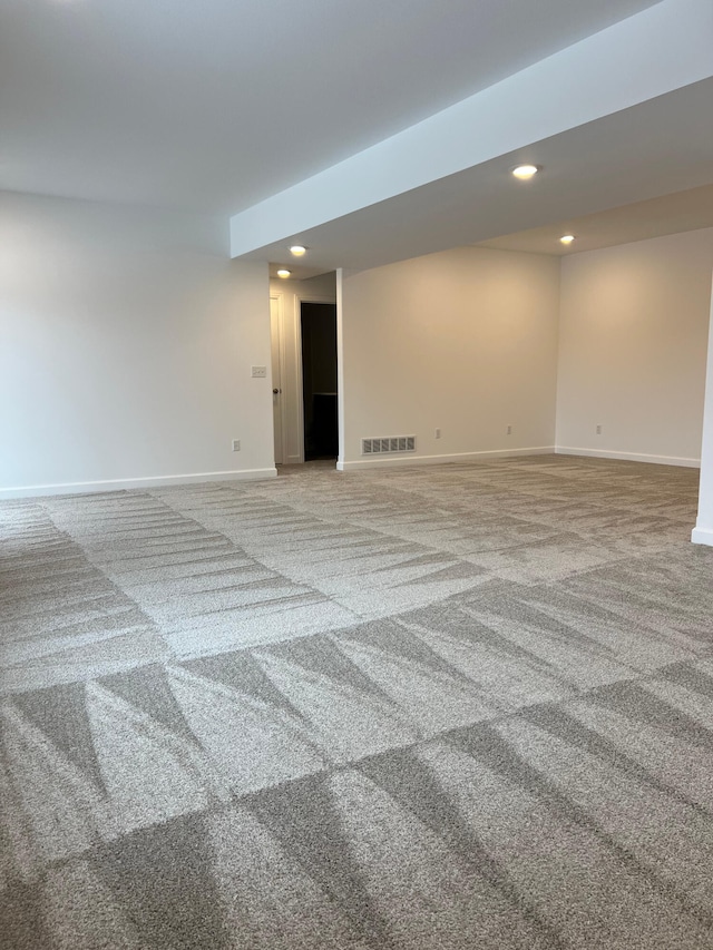 empty room featuring baseboards, carpet flooring, visible vents, and recessed lighting