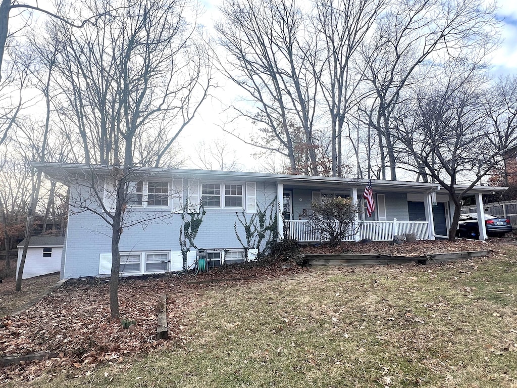 view of front of home featuring brick siding and a porch