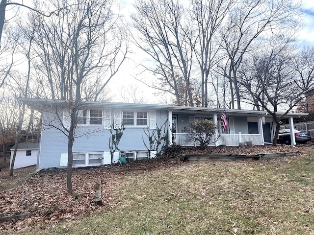 view of front of home featuring brick siding and a porch