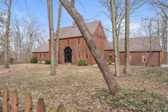 view of front facade with roof with shingles