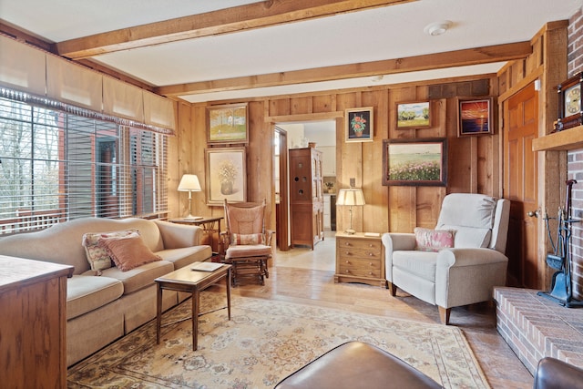 living room featuring beamed ceiling, a fireplace, wooden walls, and wood finished floors