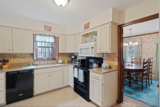 kitchen featuring wallpapered walls, a sink, black appliances, light countertops, and a chandelier