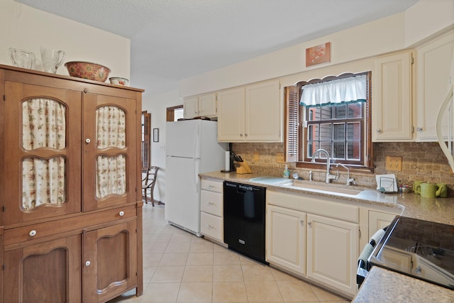 kitchen featuring a sink, range with electric stovetop, freestanding refrigerator, light countertops, and dishwasher