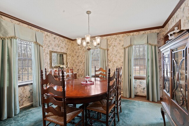 carpeted dining room with a chandelier, a healthy amount of sunlight, wallpapered walls, and ornamental molding