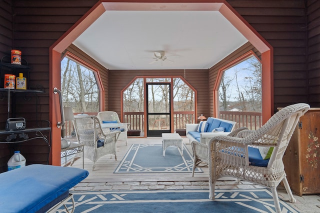 sunroom featuring a healthy amount of sunlight and a ceiling fan