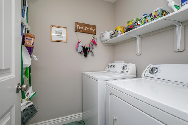 clothes washing area with washer and clothes dryer and laundry area