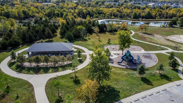 birds eye view of property featuring a view of trees and a water view