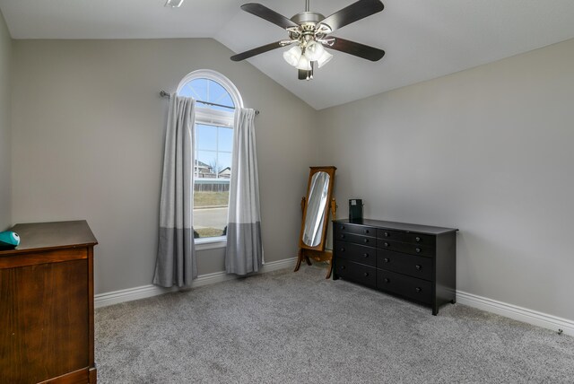 carpeted bedroom featuring baseboards, lofted ceiling, and a ceiling fan