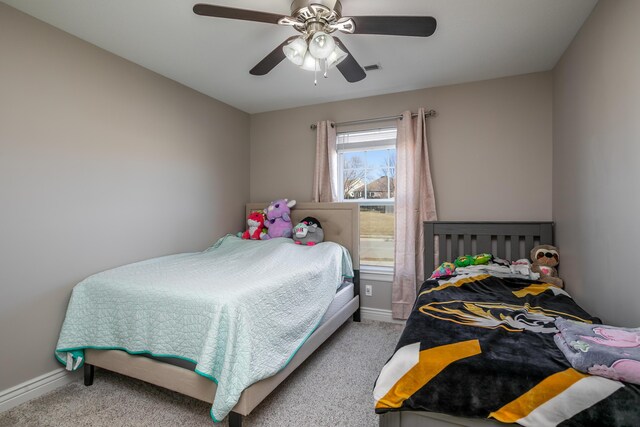 carpeted bedroom with baseboards and a ceiling fan