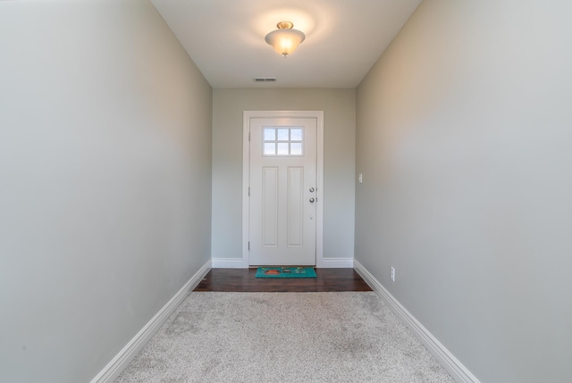 doorway to outside featuring visible vents and baseboards