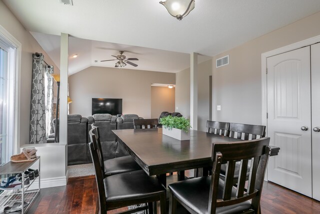 dining room with visible vents, lofted ceiling, wood finished floors, and a ceiling fan