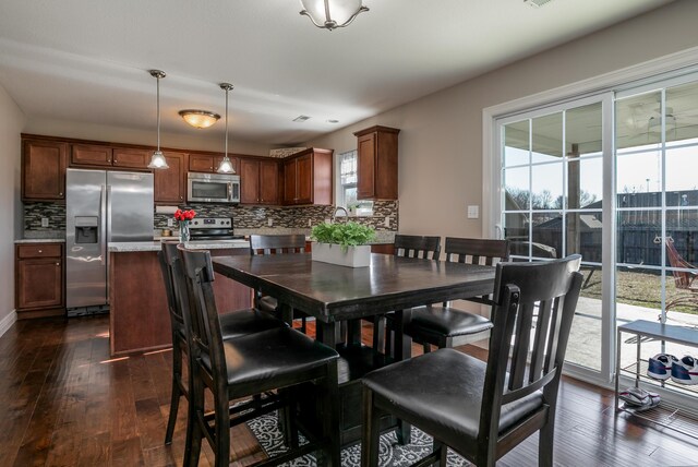 dining space featuring dark wood-type flooring