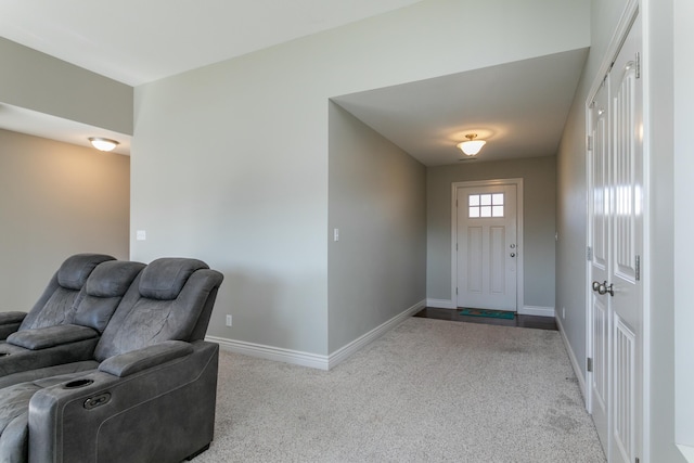 foyer entrance featuring baseboards and carpet floors