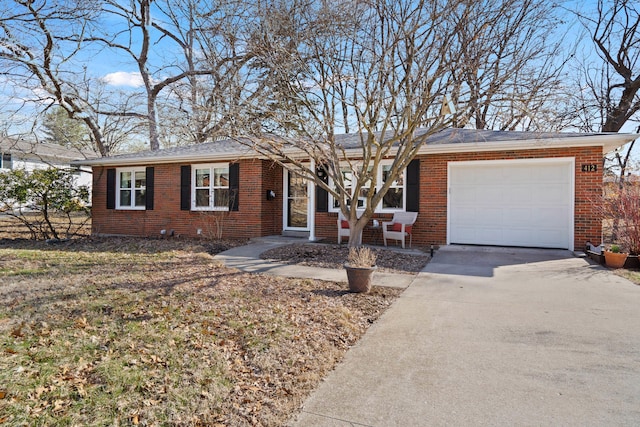 ranch-style house featuring a garage, driveway, and brick siding