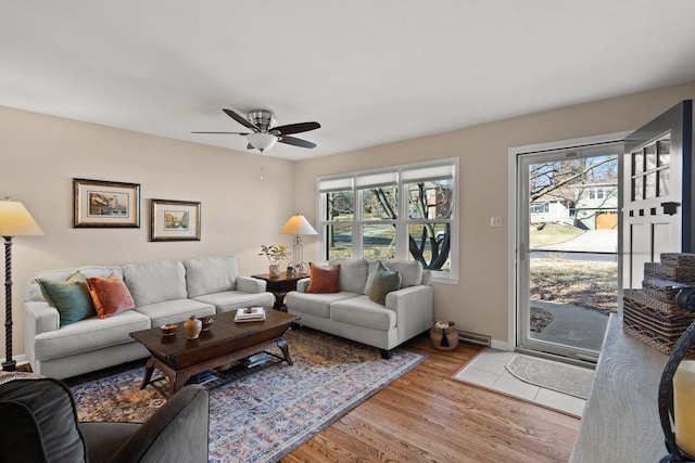 living room with a healthy amount of sunlight, ceiling fan, baseboards, and wood finished floors