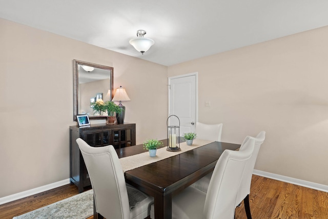 dining area with wood finished floors and baseboards