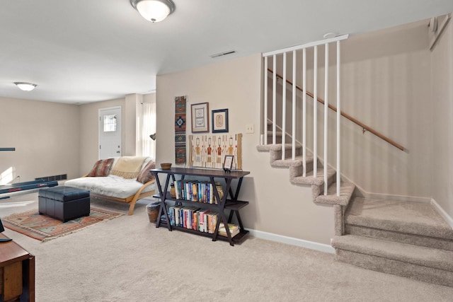 carpeted living room featuring stairway, visible vents, and baseboards