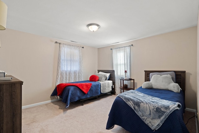 bedroom featuring carpet and baseboards