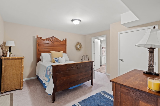 bedroom featuring light colored carpet and baseboards