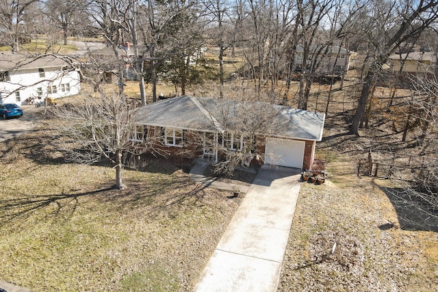 single story home featuring concrete driveway and an attached garage