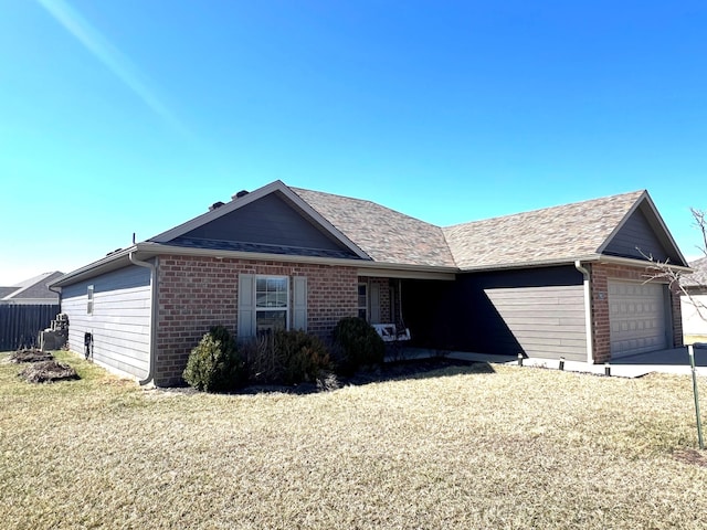 ranch-style home featuring brick siding, an attached garage, and a front yard