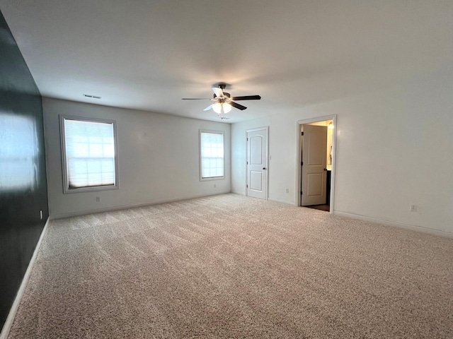 unfurnished bedroom featuring carpet flooring, visible vents, and baseboards