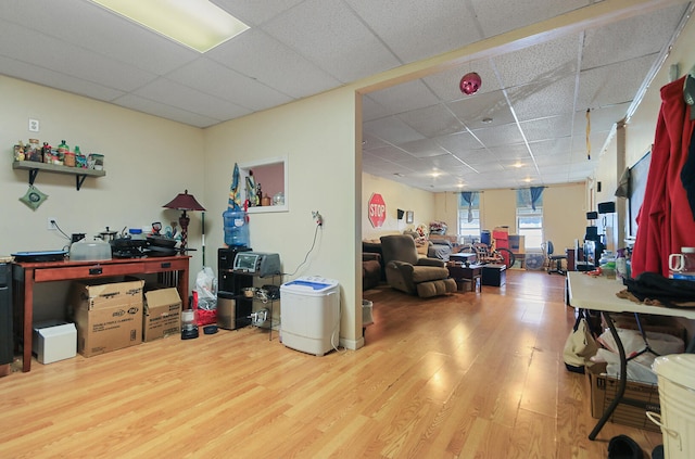 miscellaneous room featuring wood finished floors and a paneled ceiling