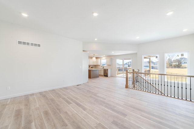 unfurnished living room featuring recessed lighting, visible vents, baseboards, and light wood-style flooring